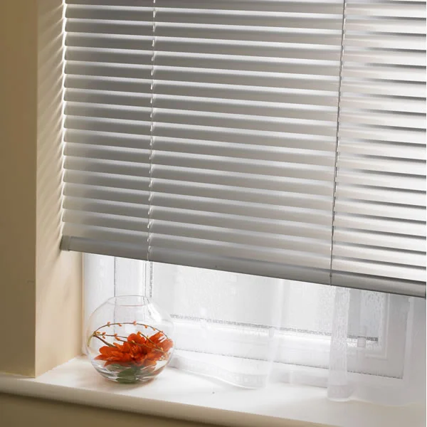 White Venetian Blinds installed in a window with a red showpiece