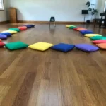 Teak Wooden Flooring and some different color pillow on it